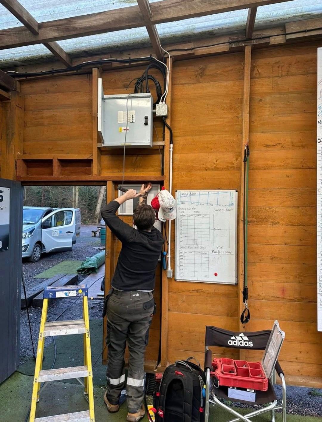 Aidan installing the new distribution board inside the range building